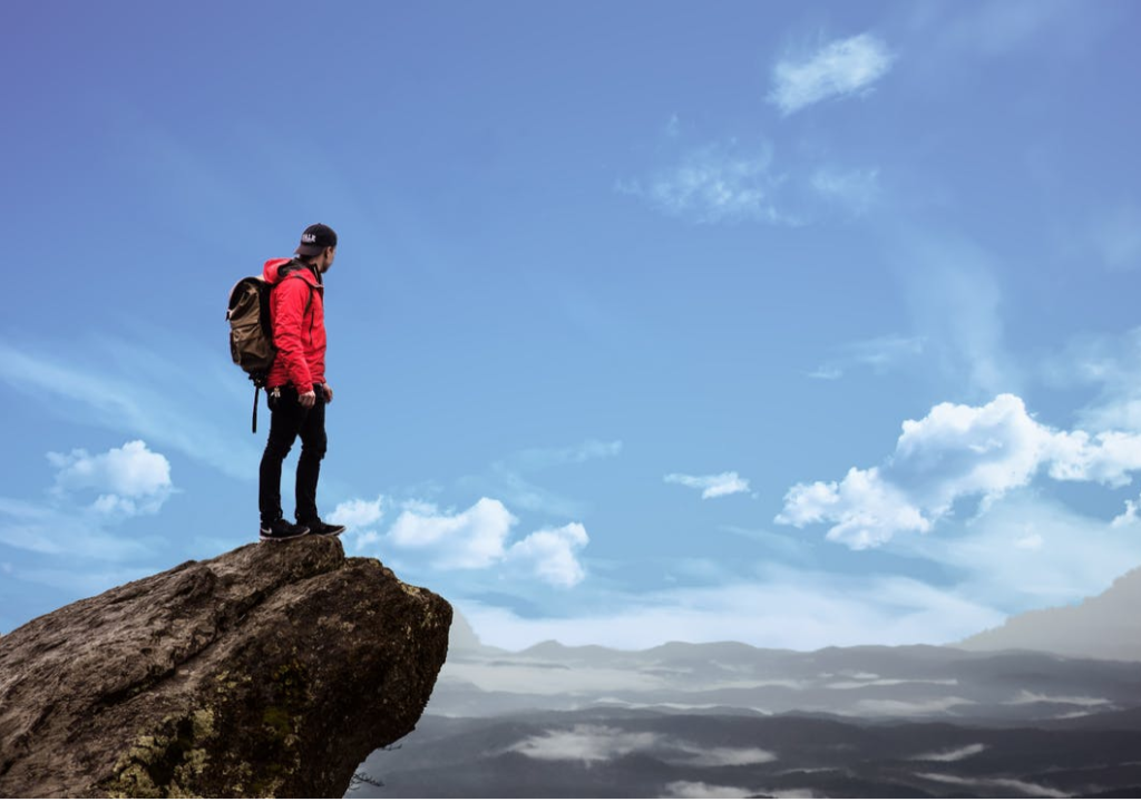 man on high rock