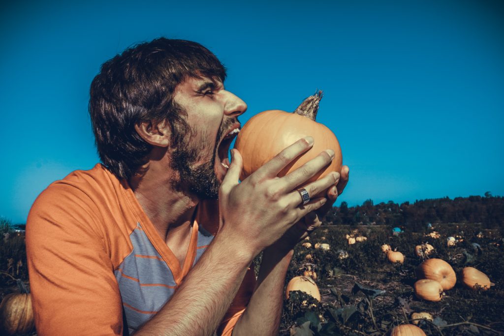 man eating pumpkin
